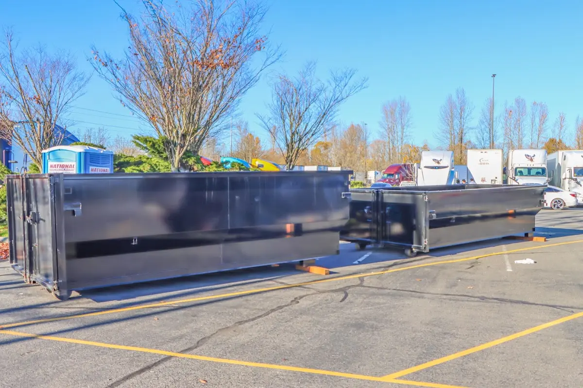 Professional dumpster rental service with roll-off container on residential driveway in Broadview Park
